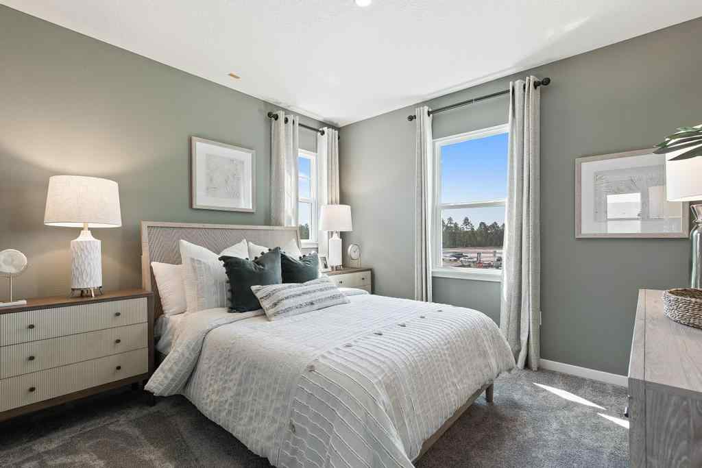 A bedroom with a large window.