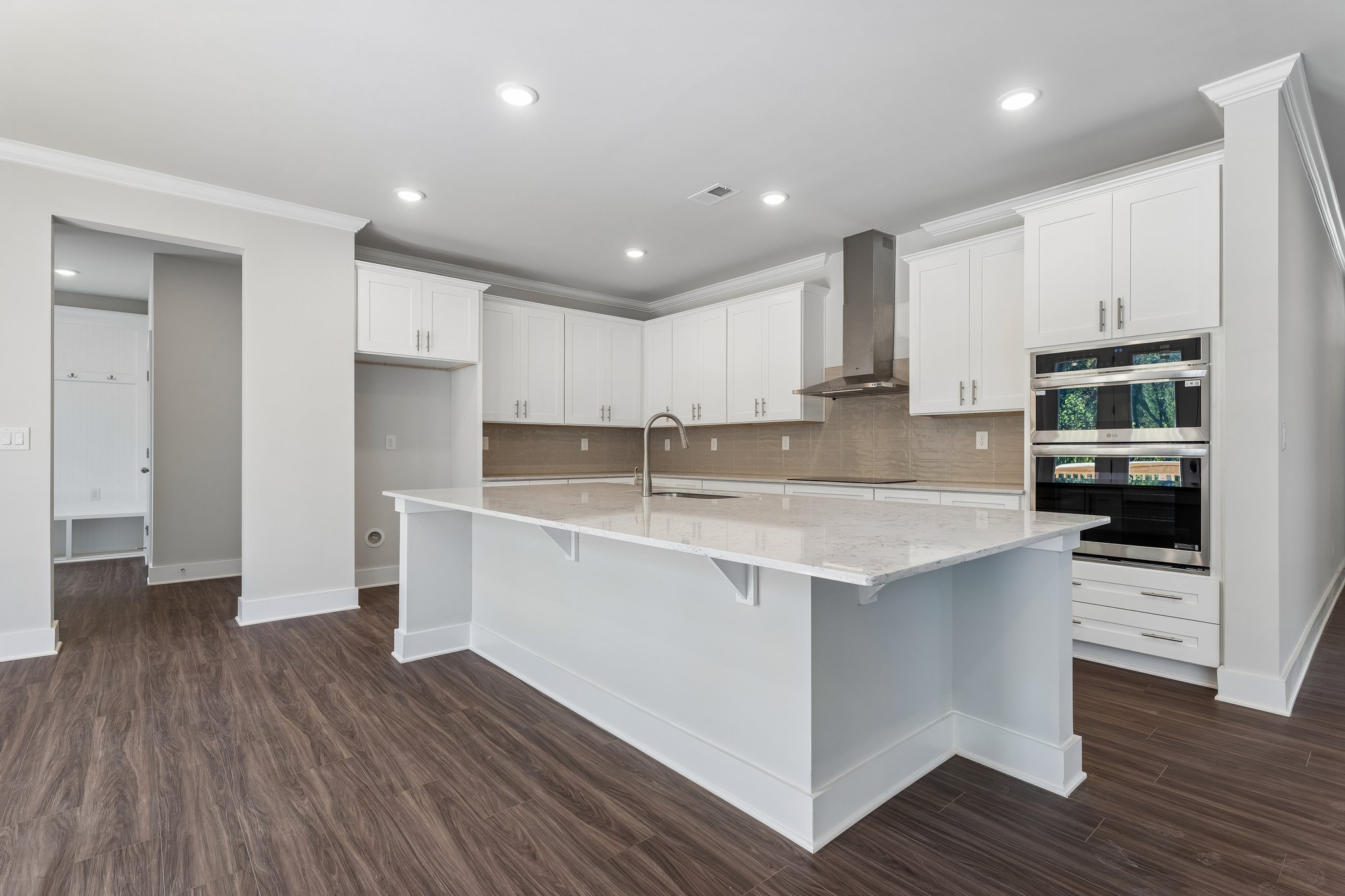 A kitchen with white cabinets.