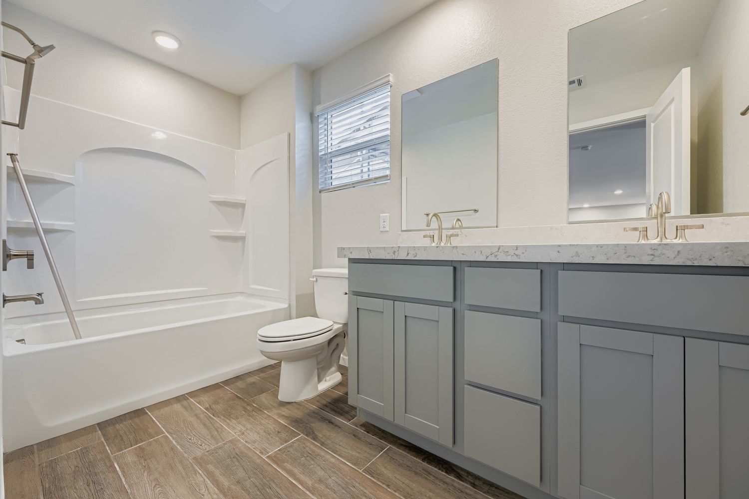A bathroom with a tub toilet and sink.