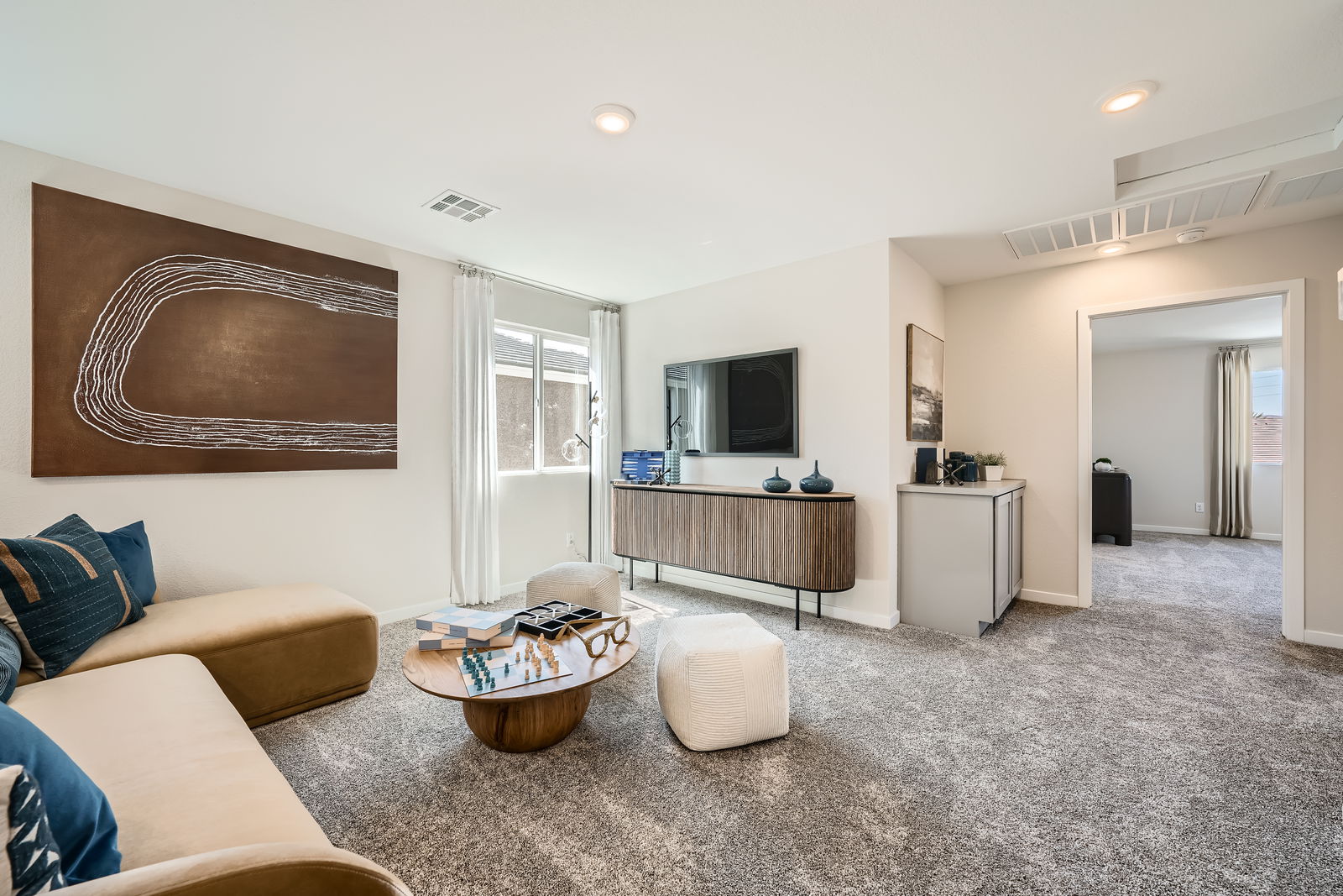 A living room with a large tv and couches.
