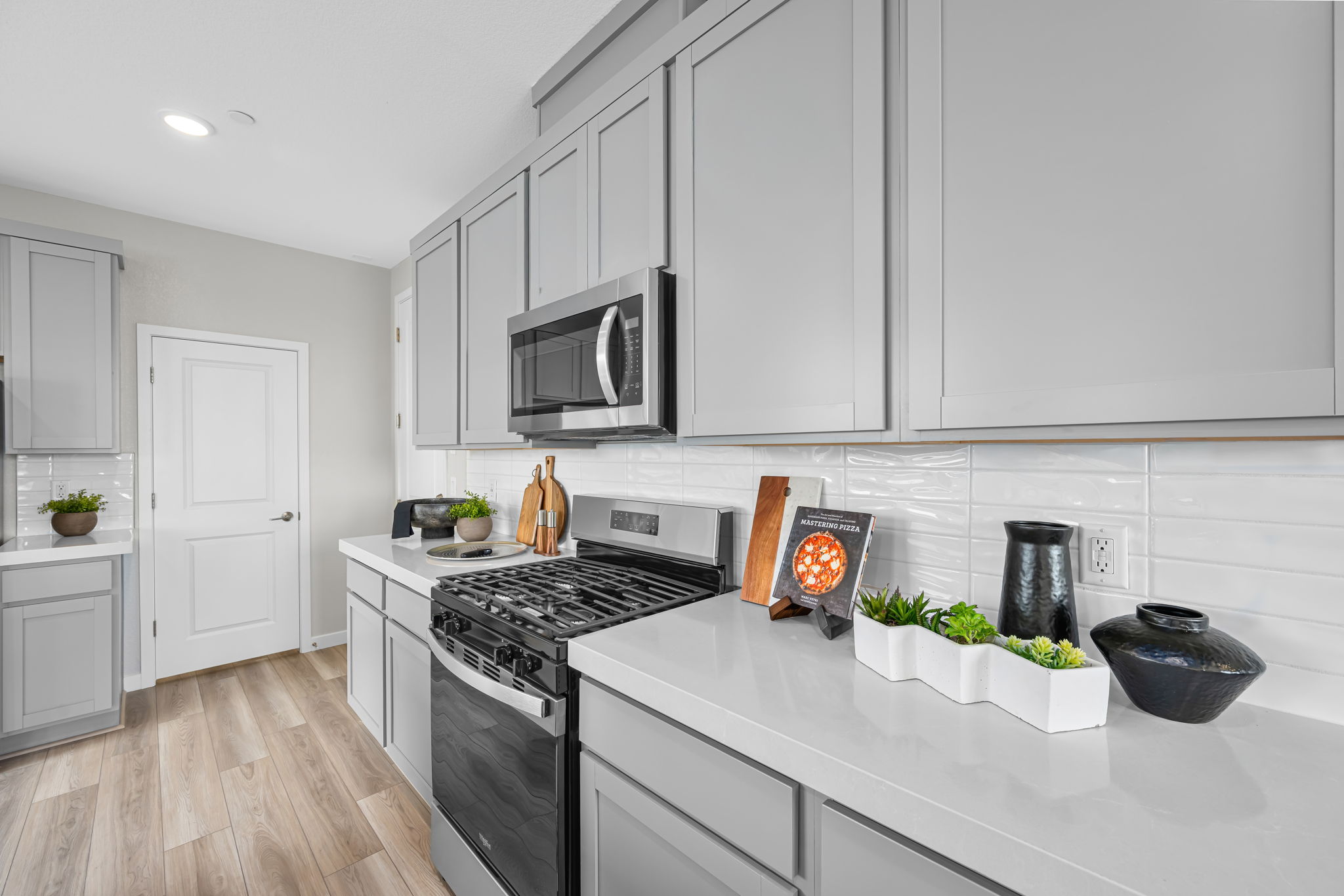 A kitchen with white cabinets.