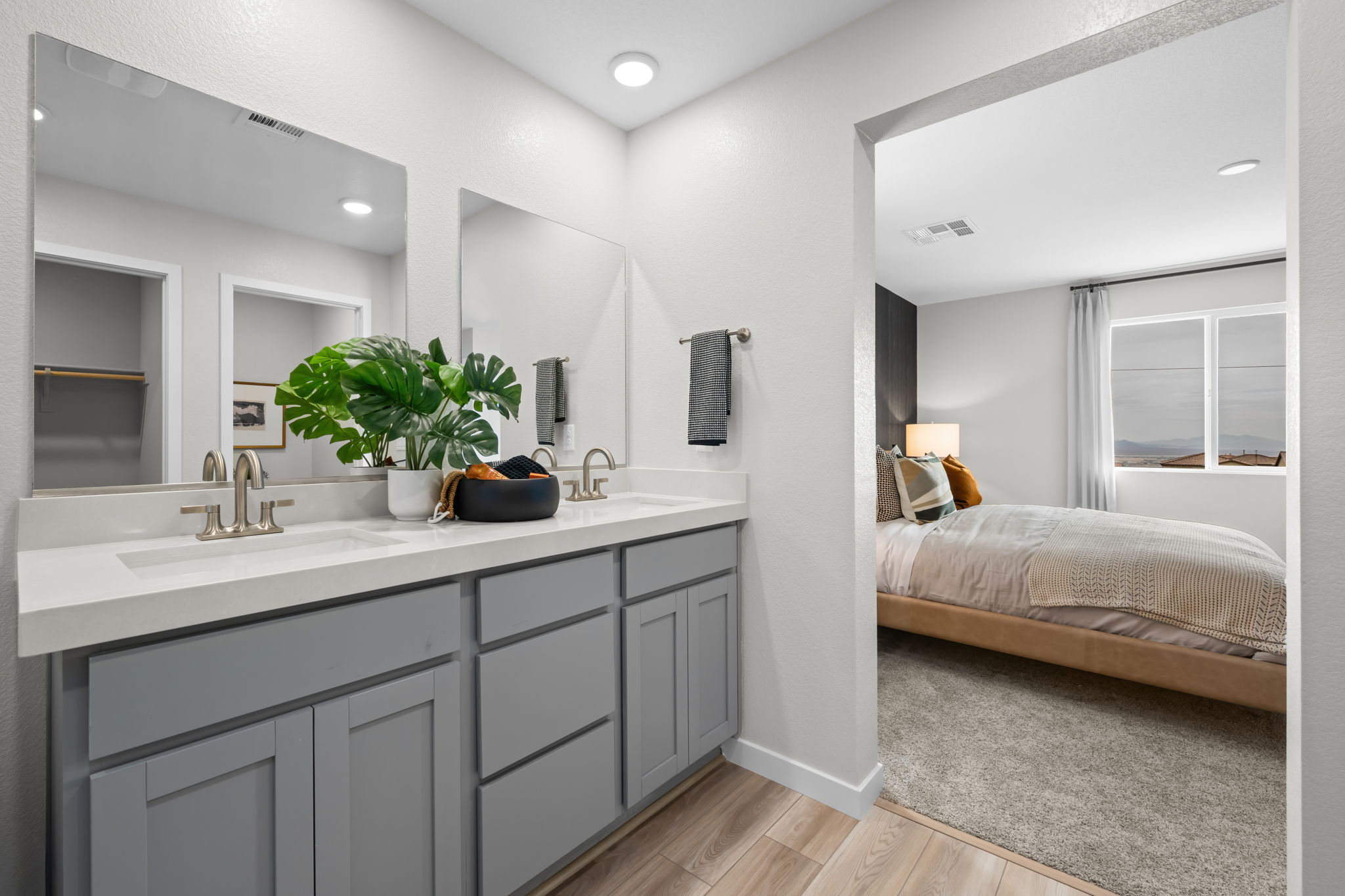 A bathroom with a bed and a sink.