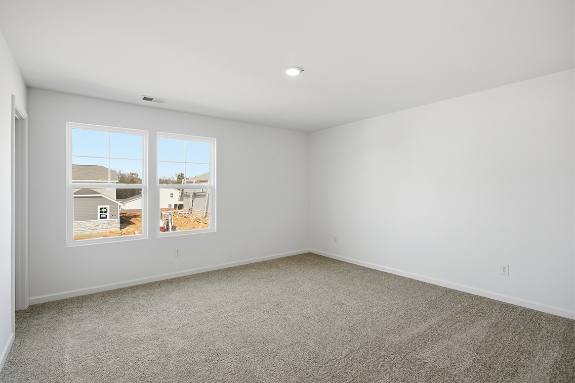 A room with a window and a carpet.