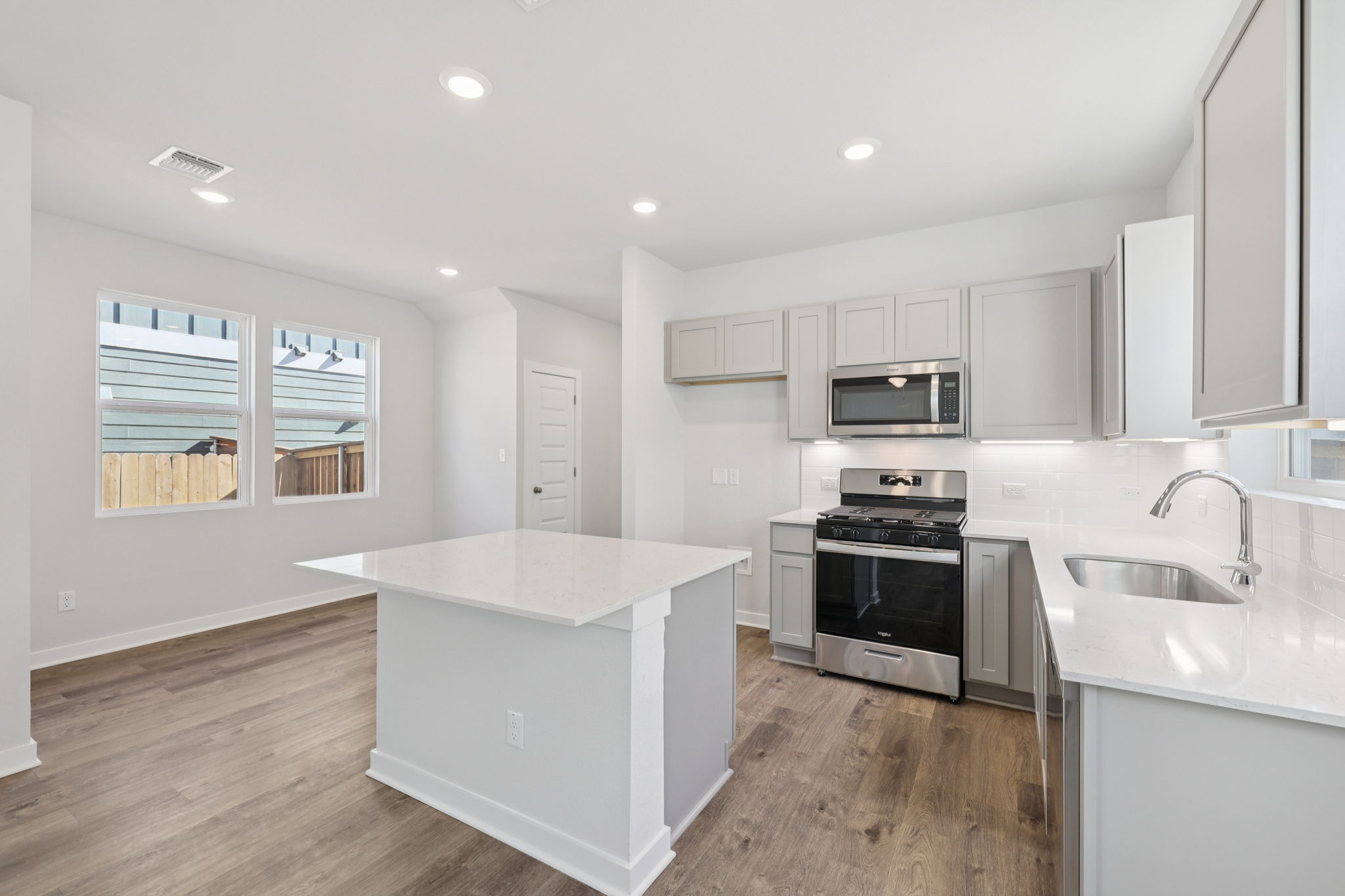 A kitchen with white cabinets.