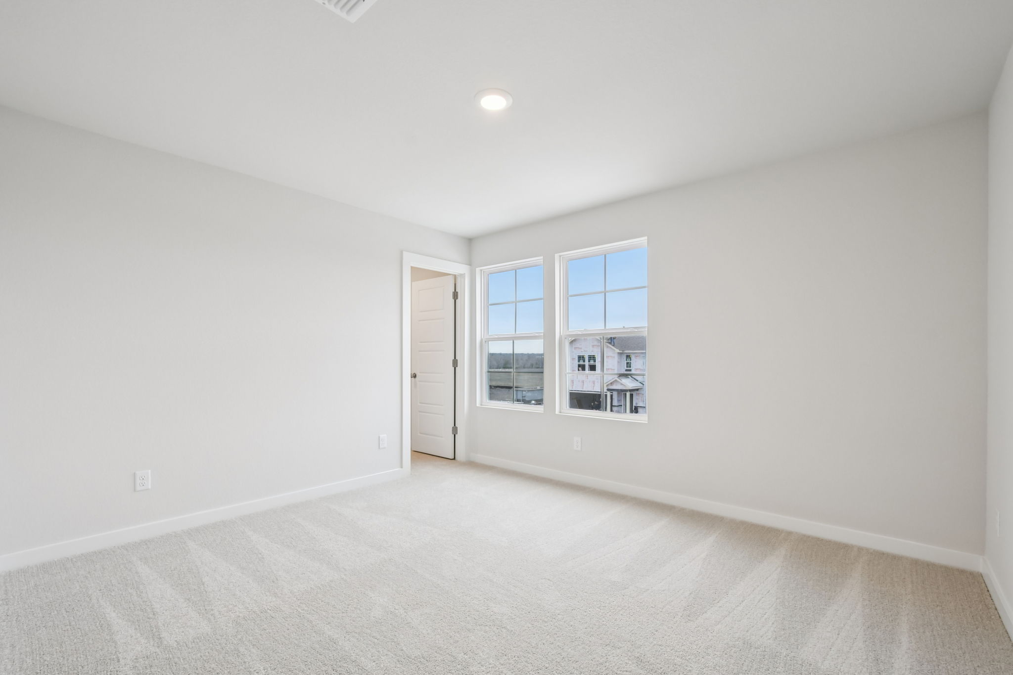 A room with a window and a door.