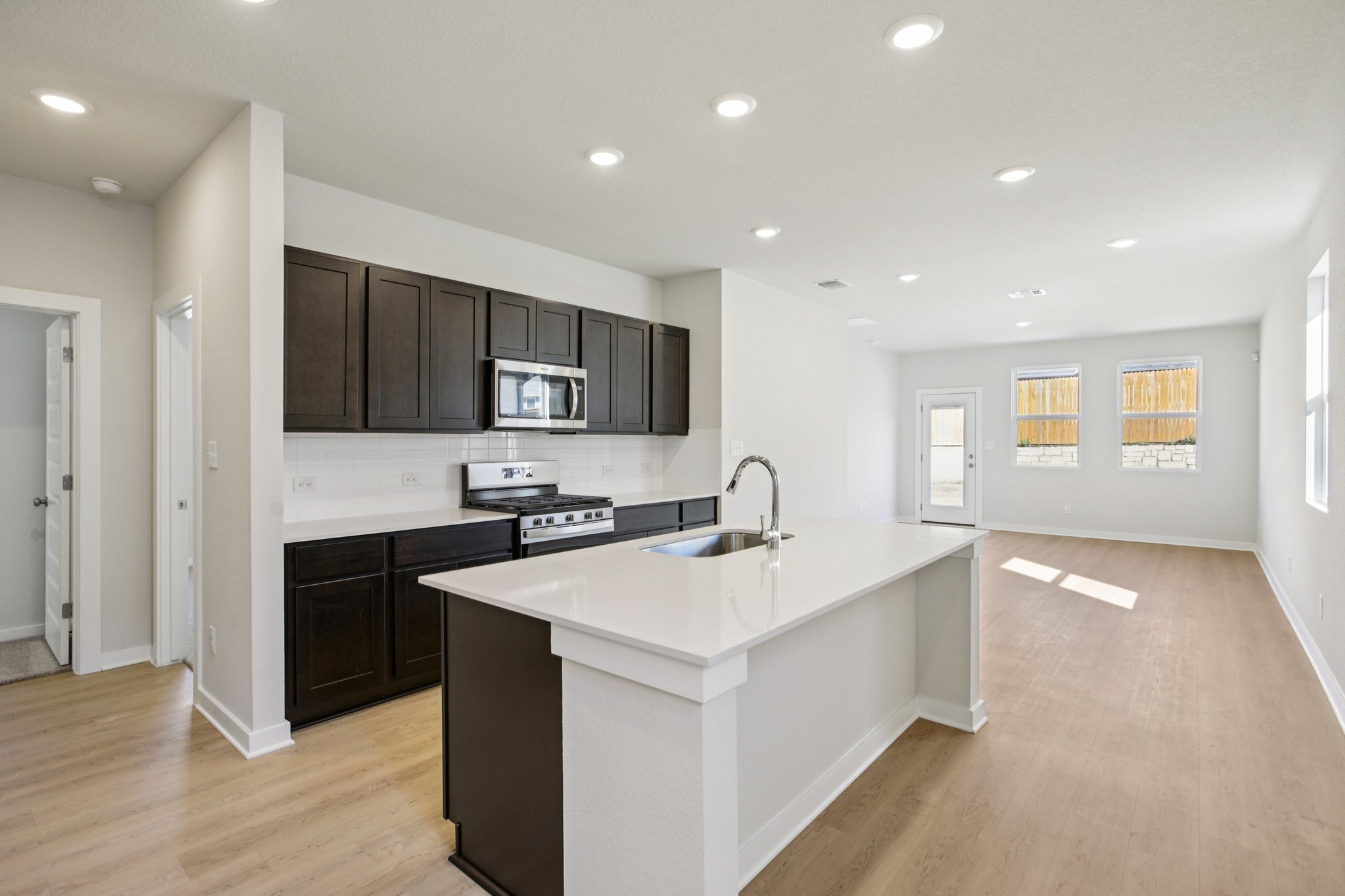 A kitchen with black cabinets.