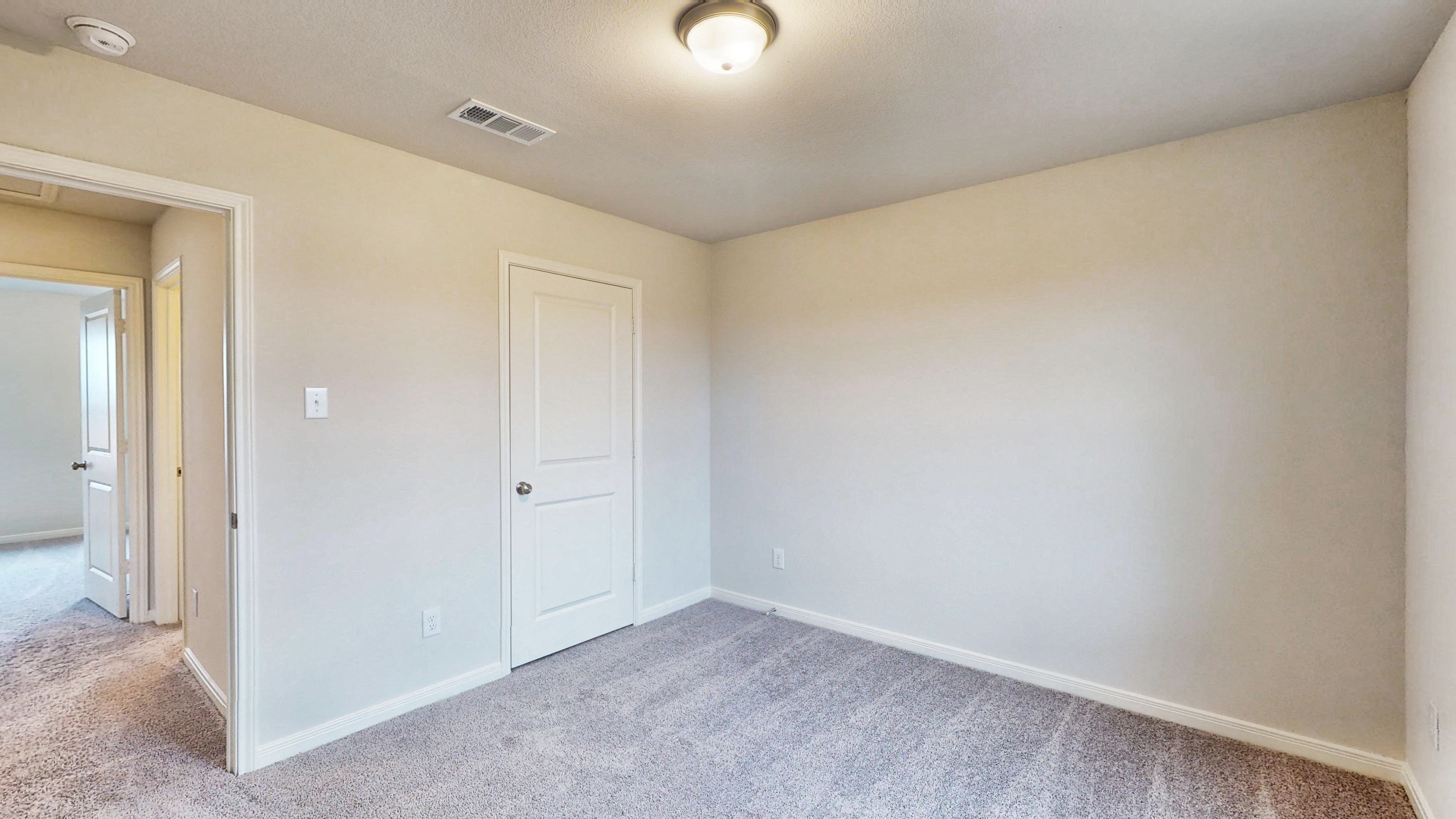 A hallway with white doors.