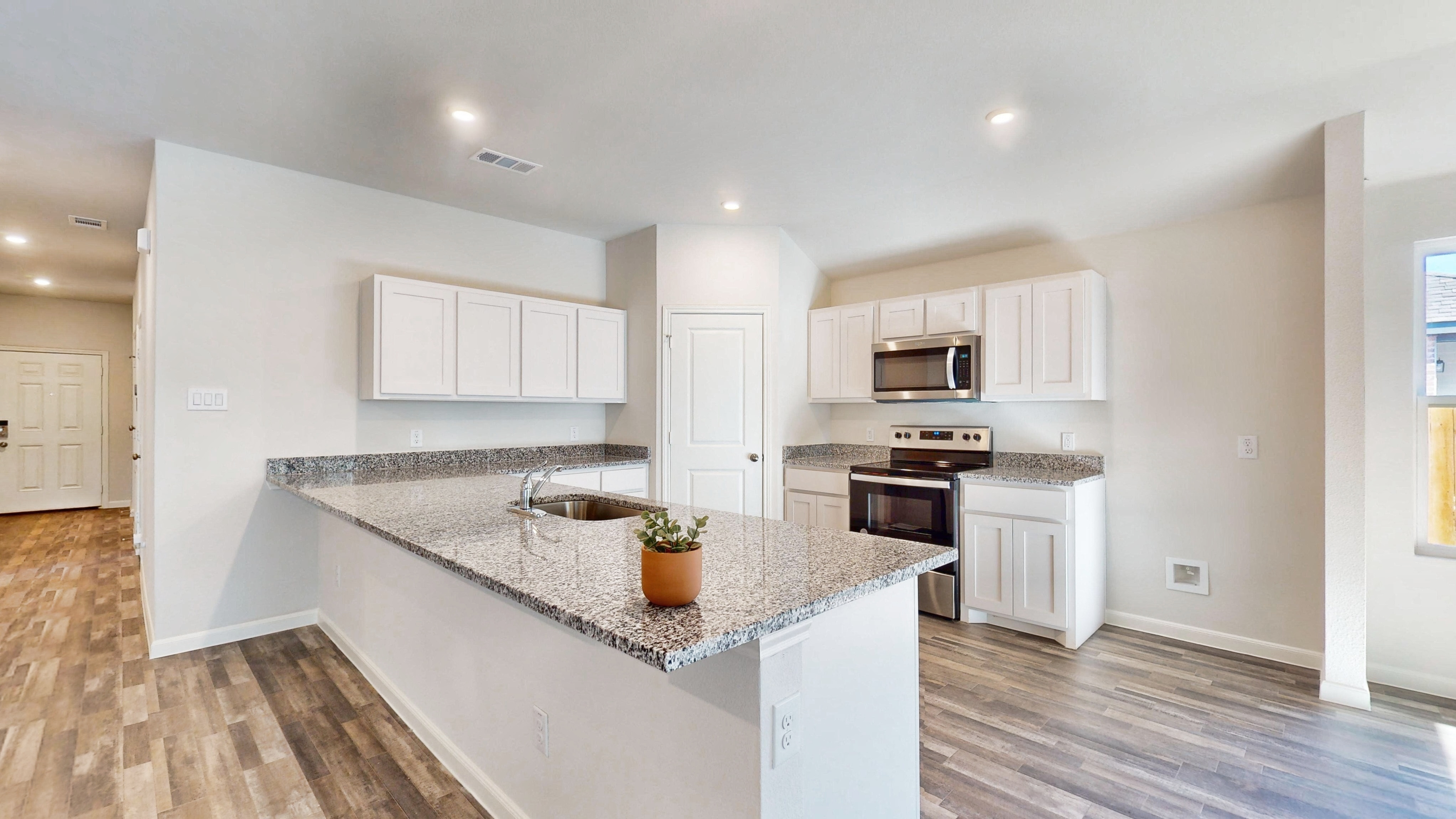 A kitchen with white cabinets.