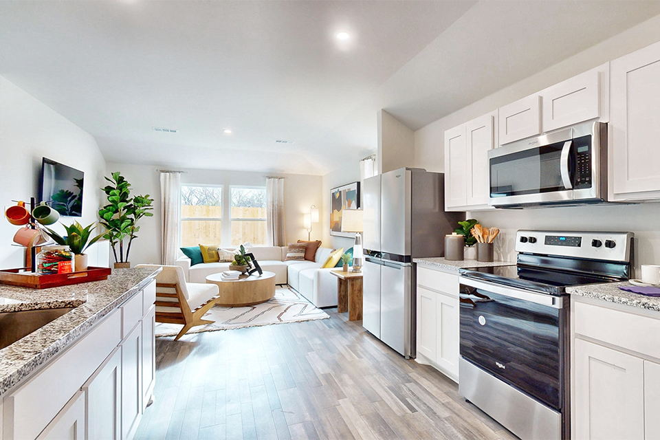 A kitchen with white cabinets.