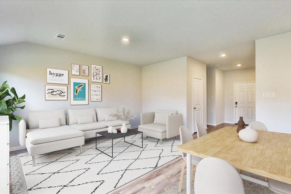 A living room with a large table and chairs.