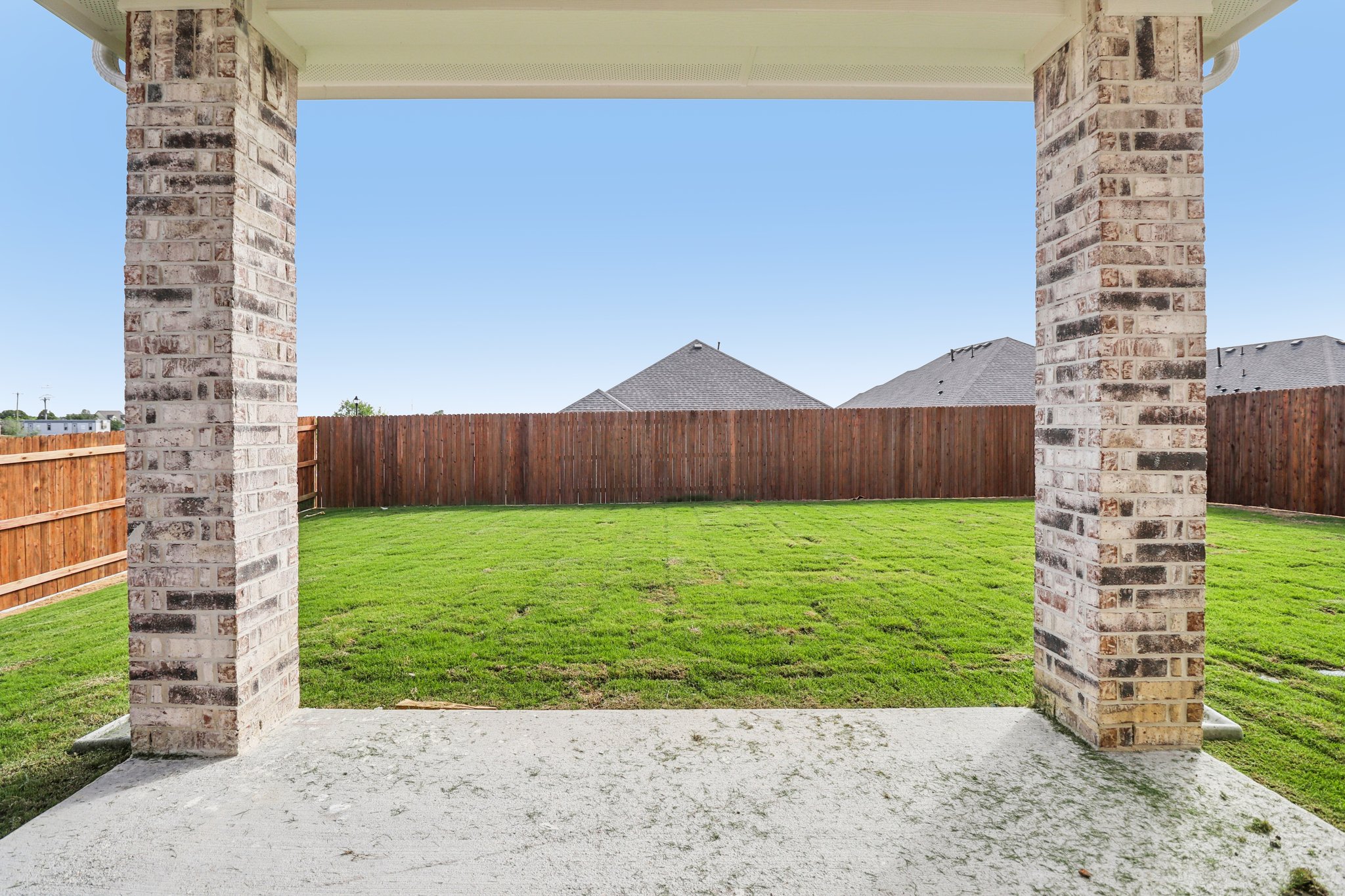 A fenced in area with a stone structure in the middle.