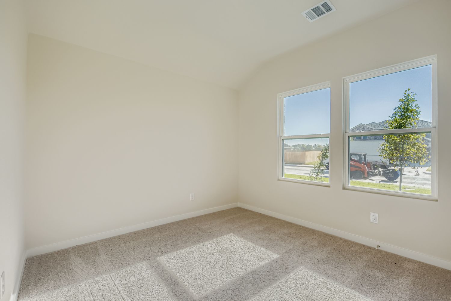 A room with a window and a rug.