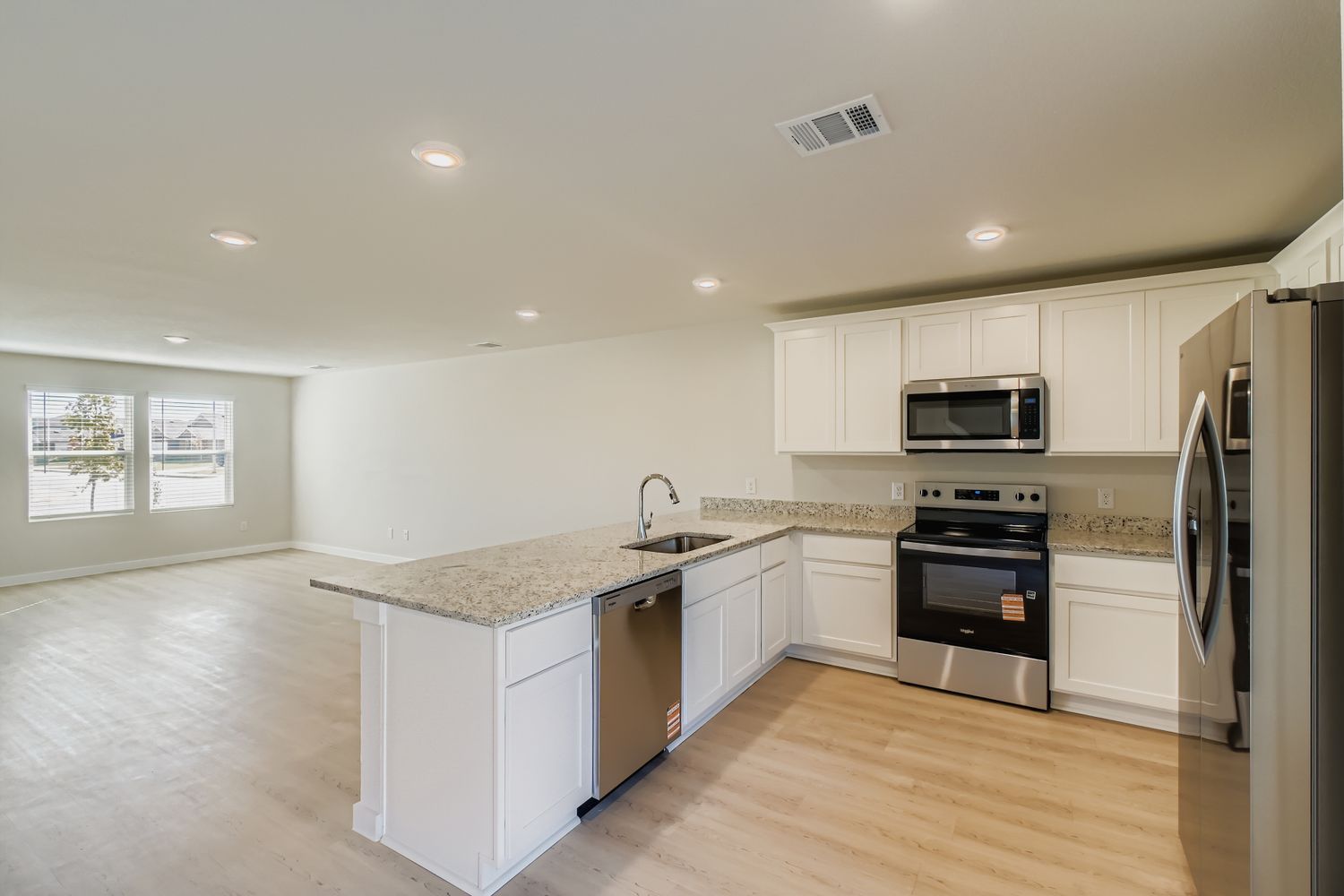 A kitchen with white cabinets.