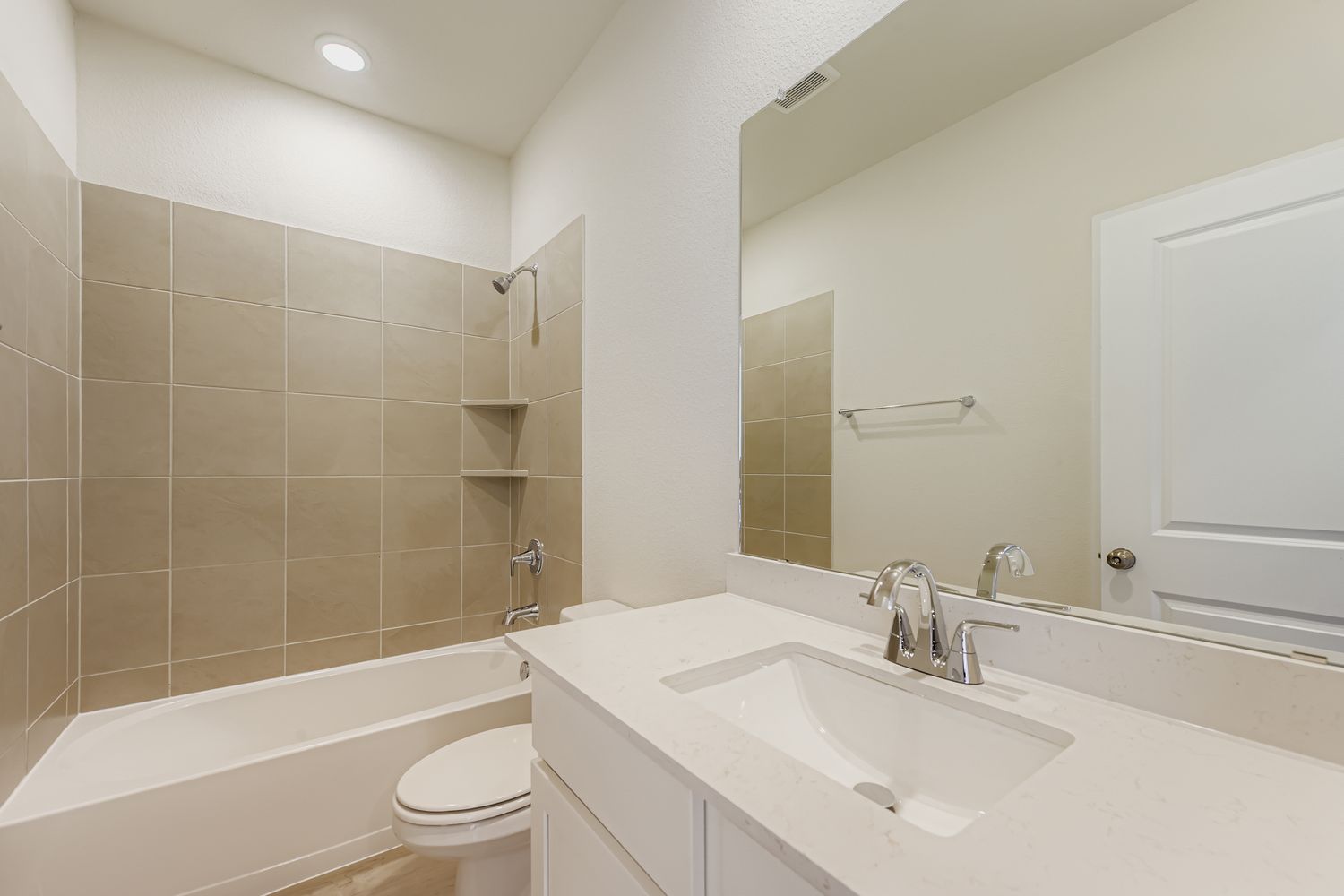 A bathroom with a tub sink and toilet.