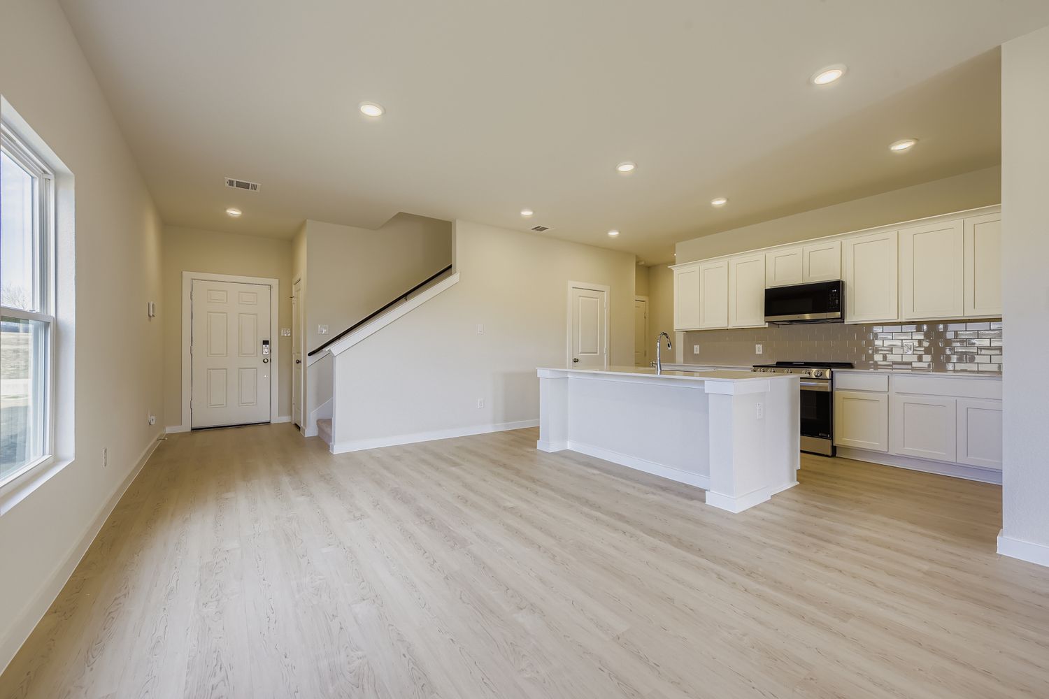 A kitchen with white cabinets.