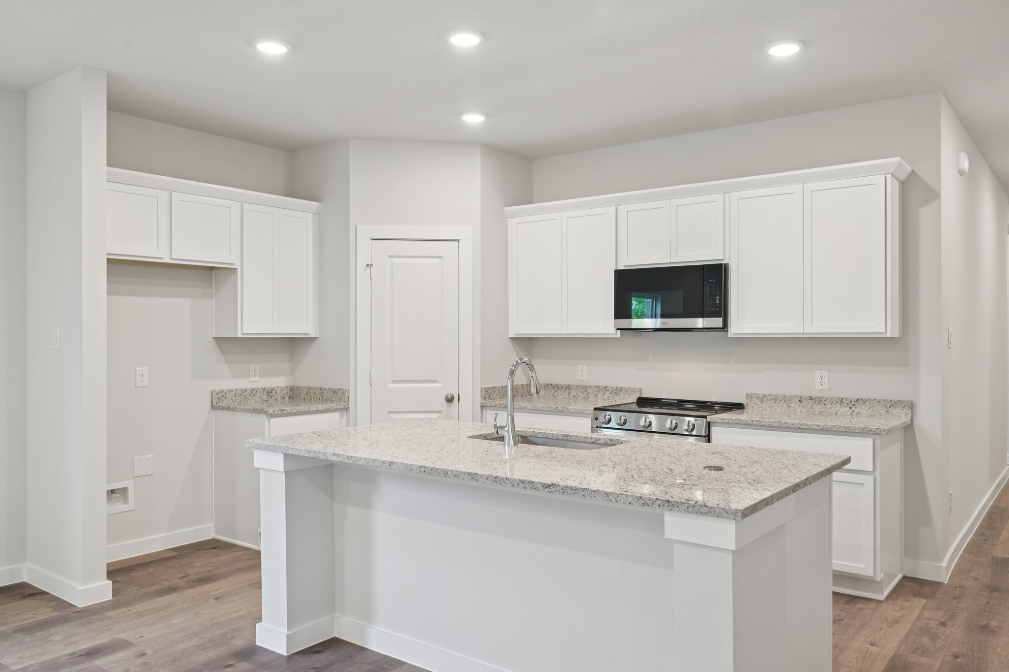 A kitchen with white cabinets.