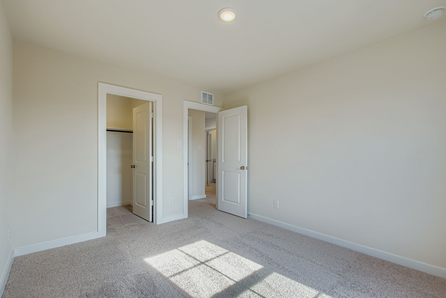A hallway with white doors.