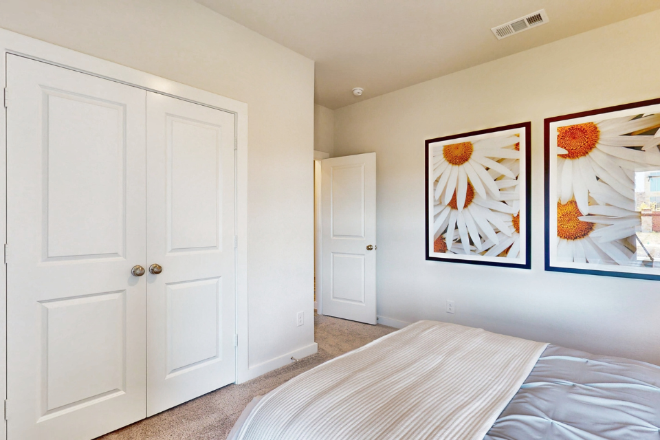 A bedroom with white doors.