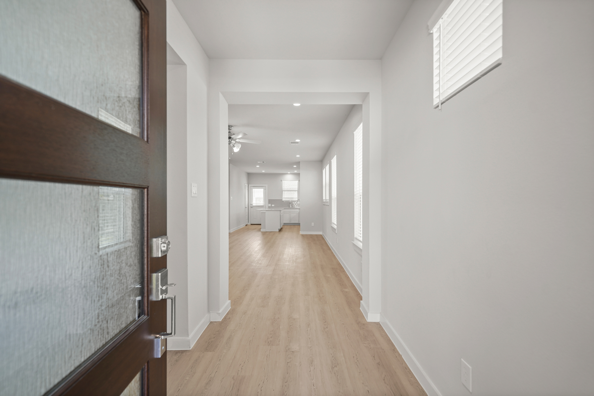 A hallway with wood floors.
