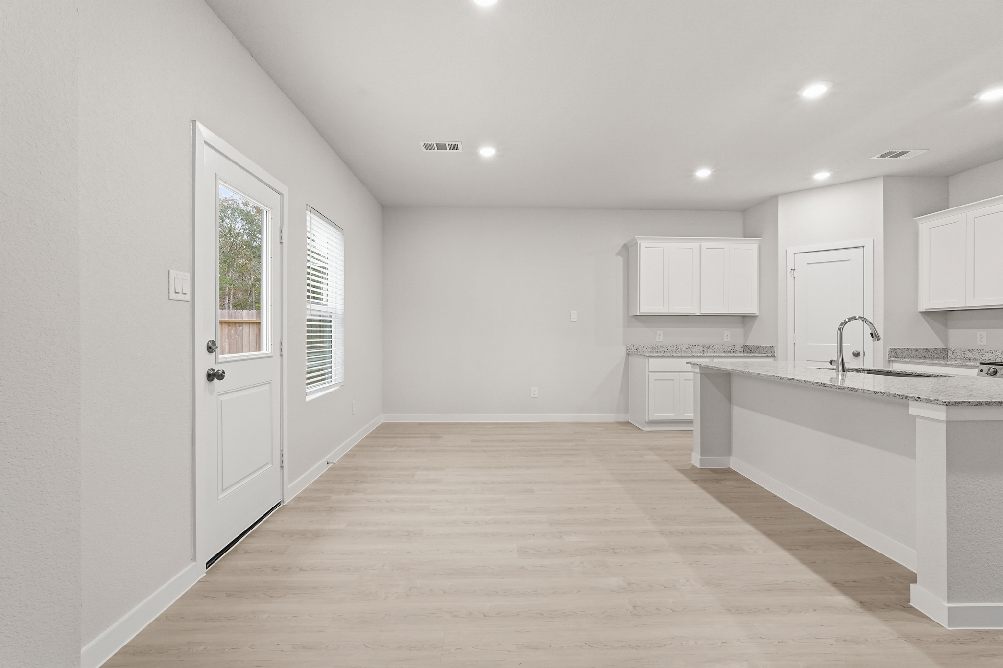 A kitchen with white cabinets.