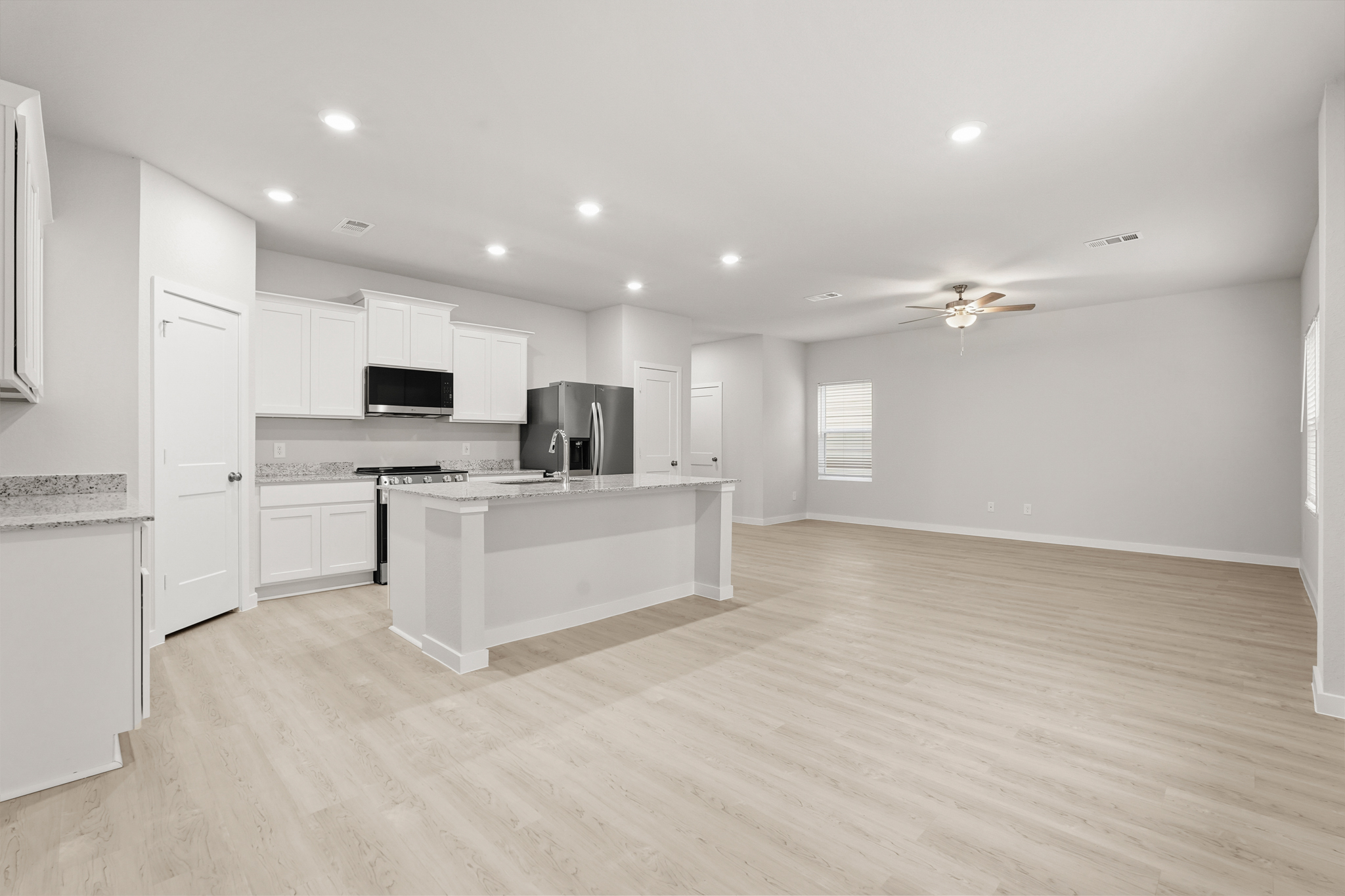 A kitchen with white cabinets.