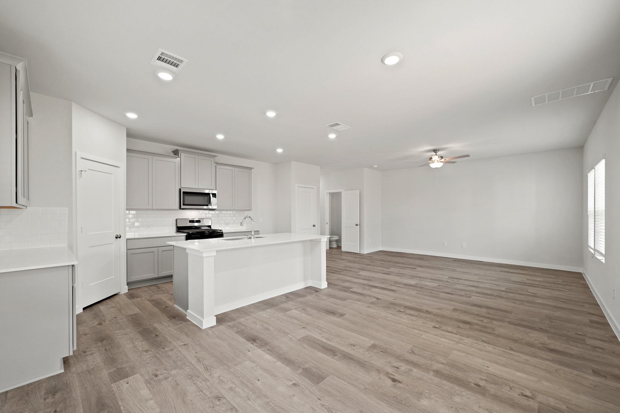 A kitchen with white cabinets.