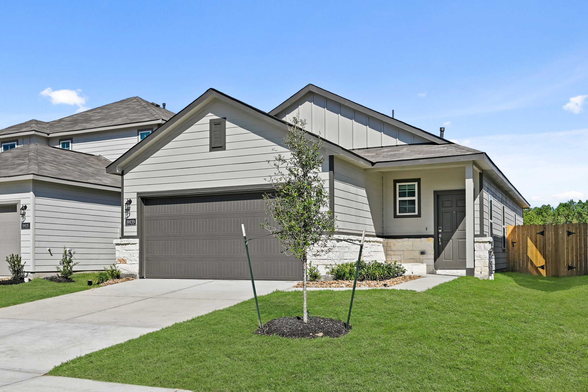 A house with a tree in the front yard.