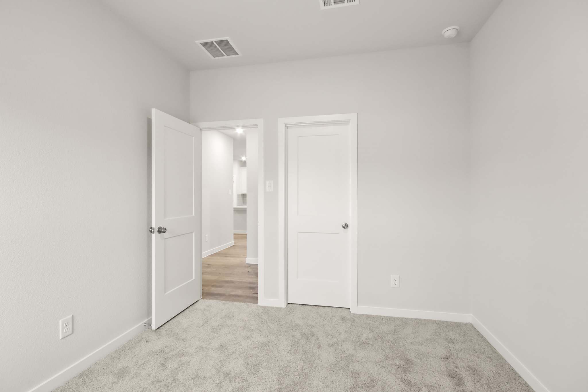 A hallway with white doors.