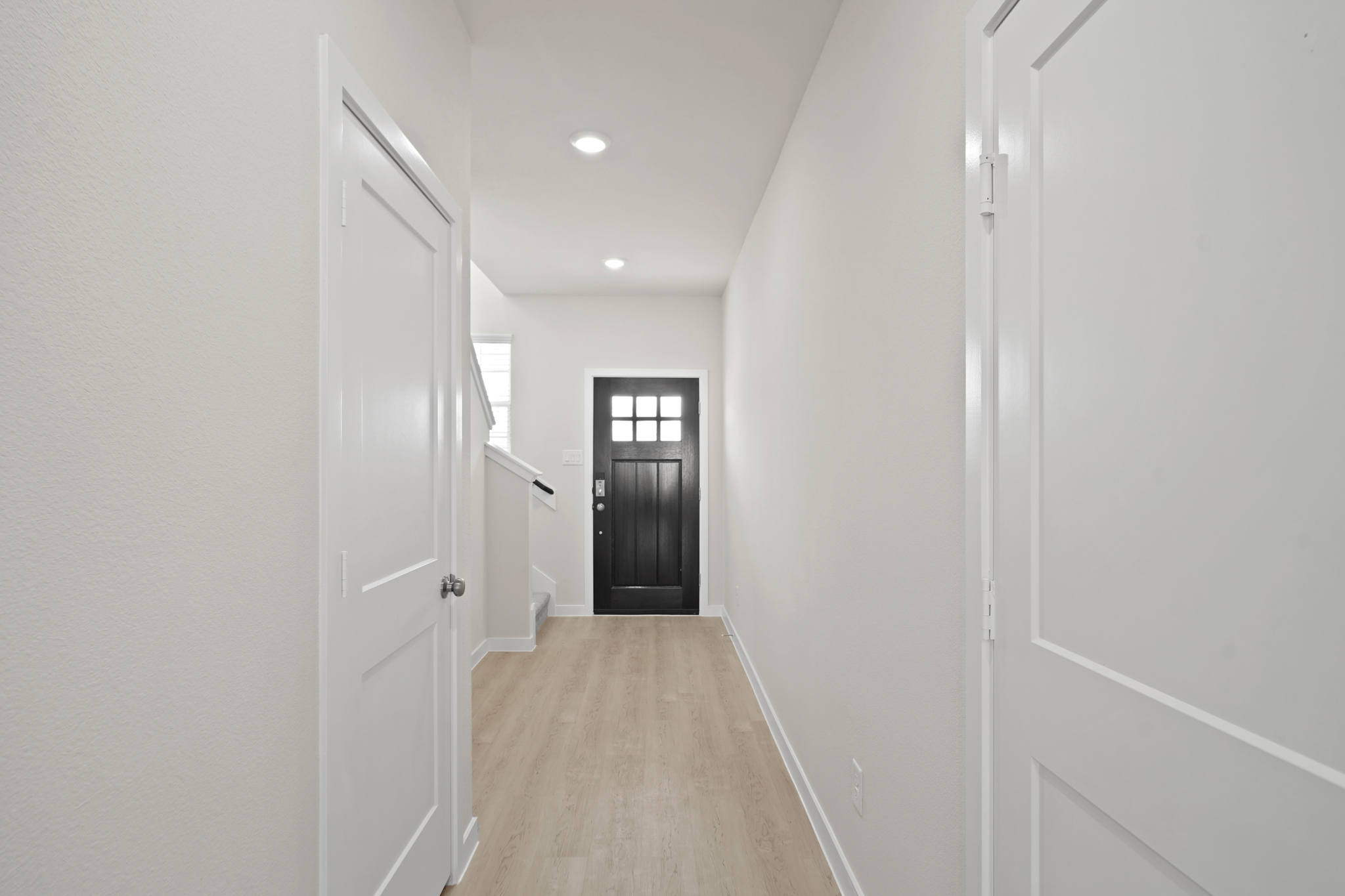 A hallway with white walls.