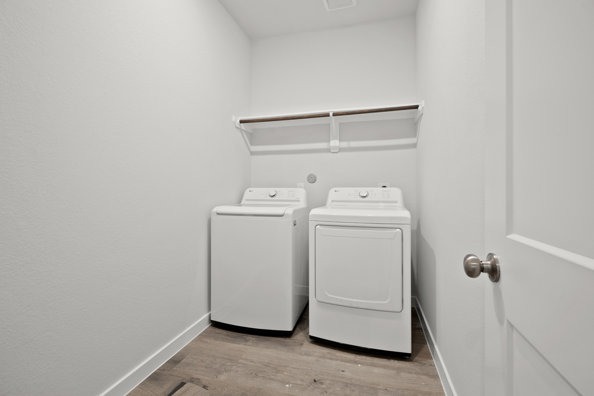 A white room with a white door and a white cabinet.