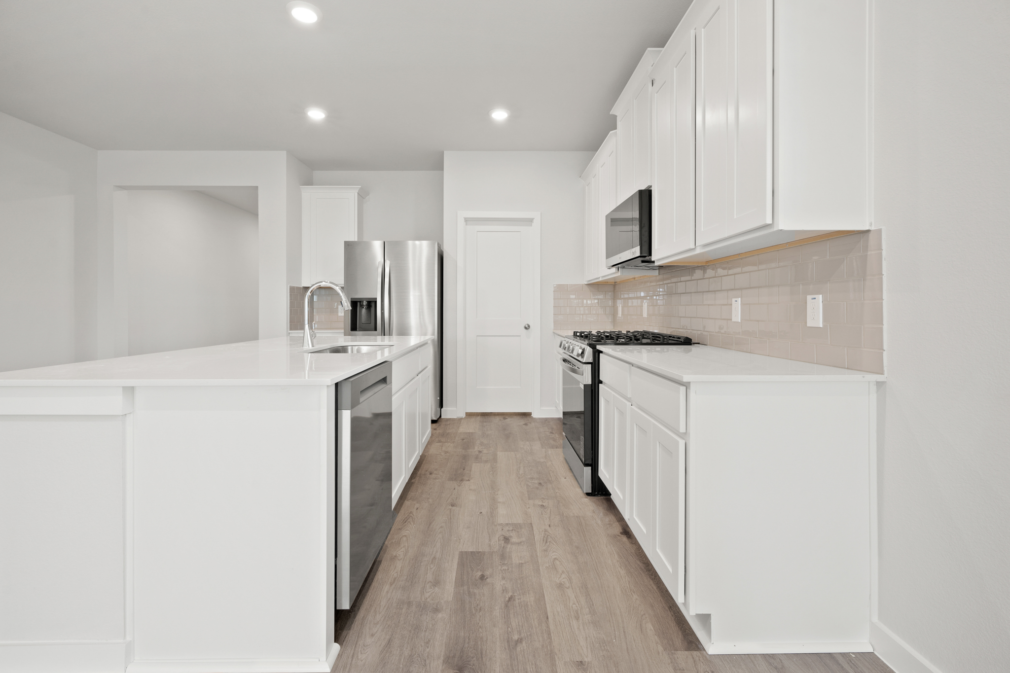 A kitchen with white cabinets.