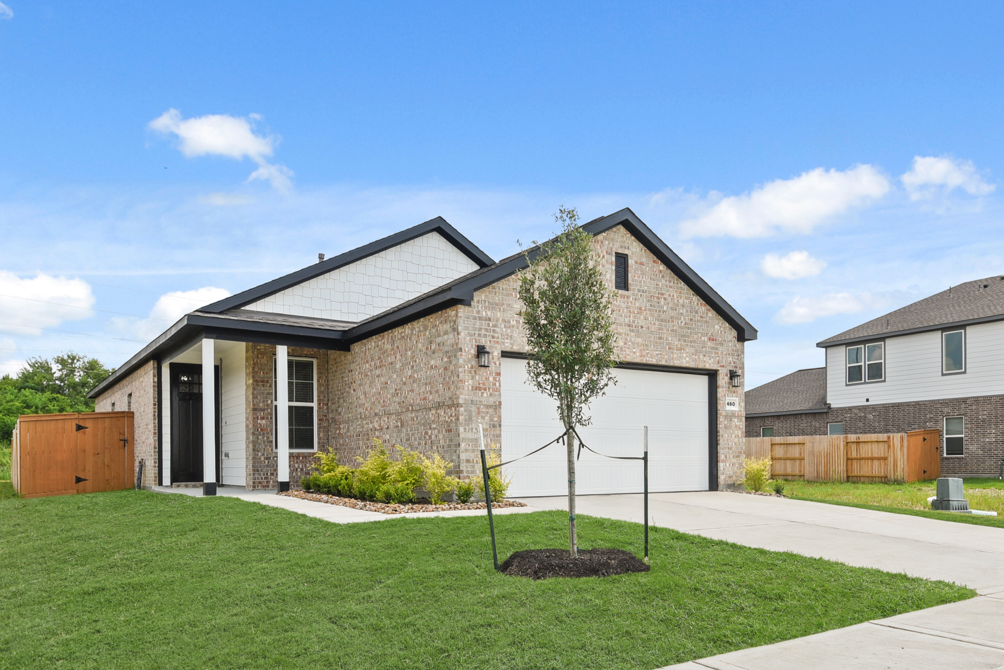 A house with a tree in the front yard.