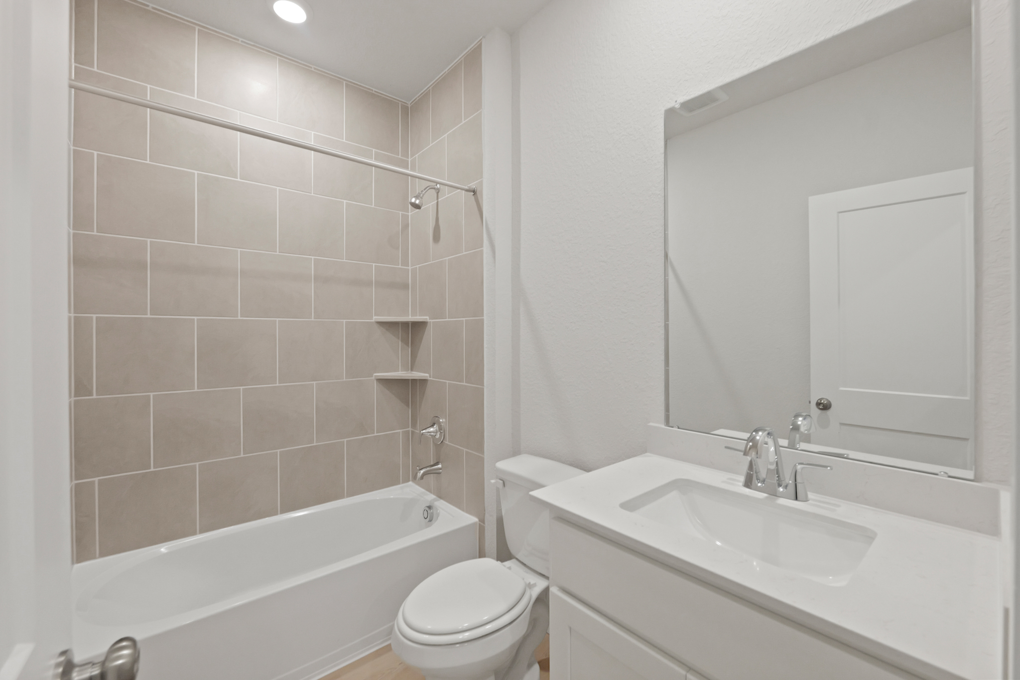A bathroom with a sink toilet and bathtub.