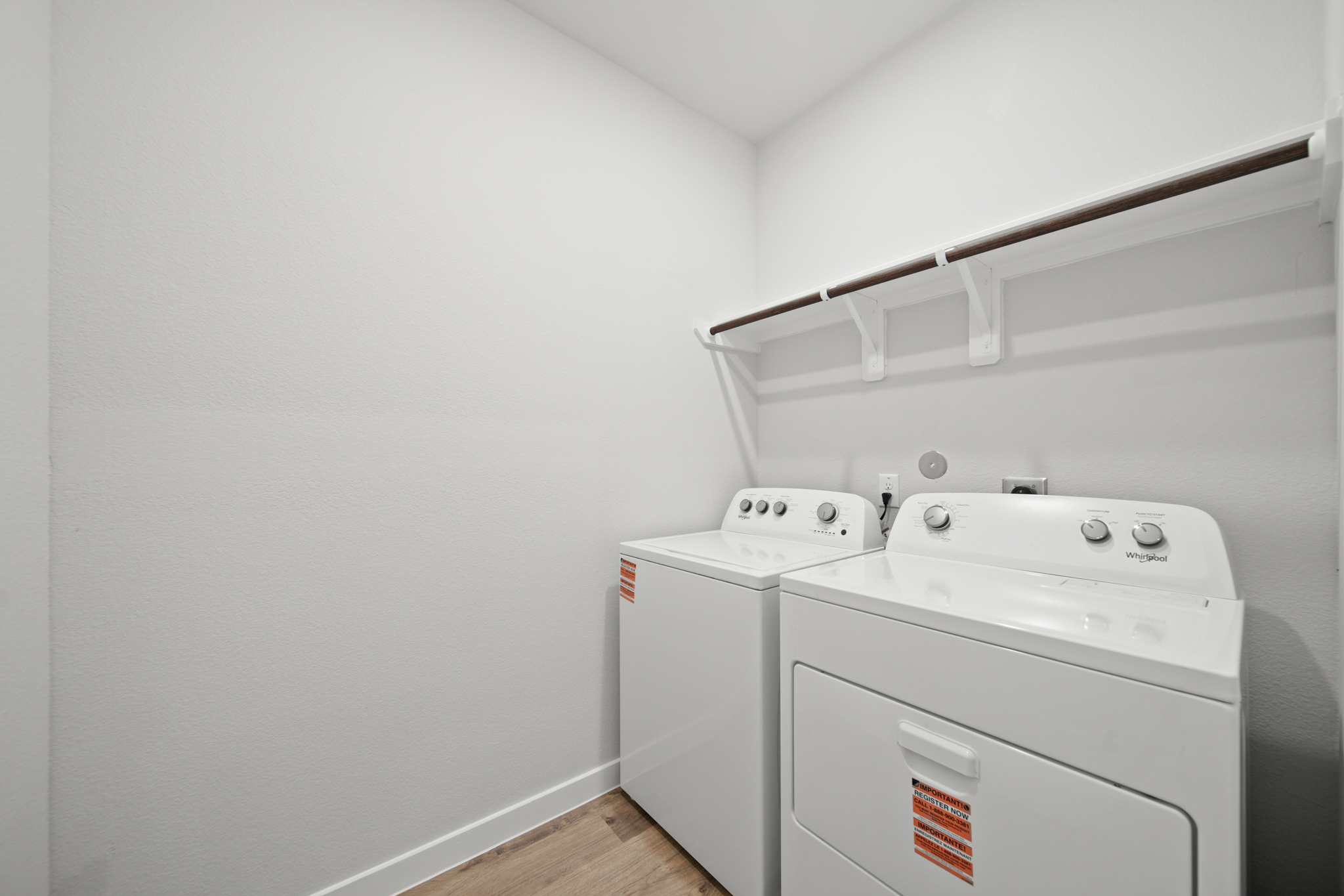 A white laundry room with a white laundry machine.