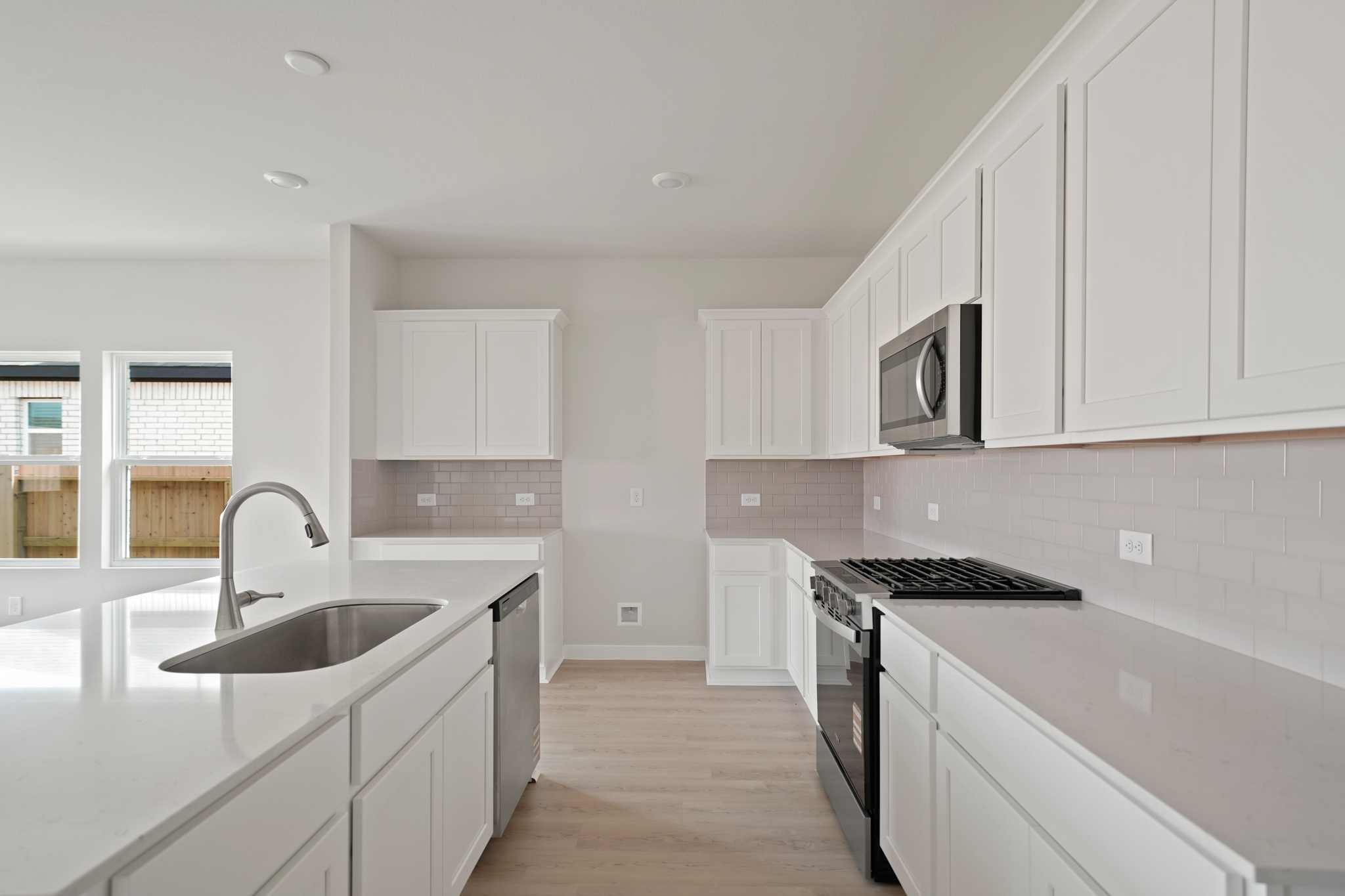 A kitchen with white cabinets.