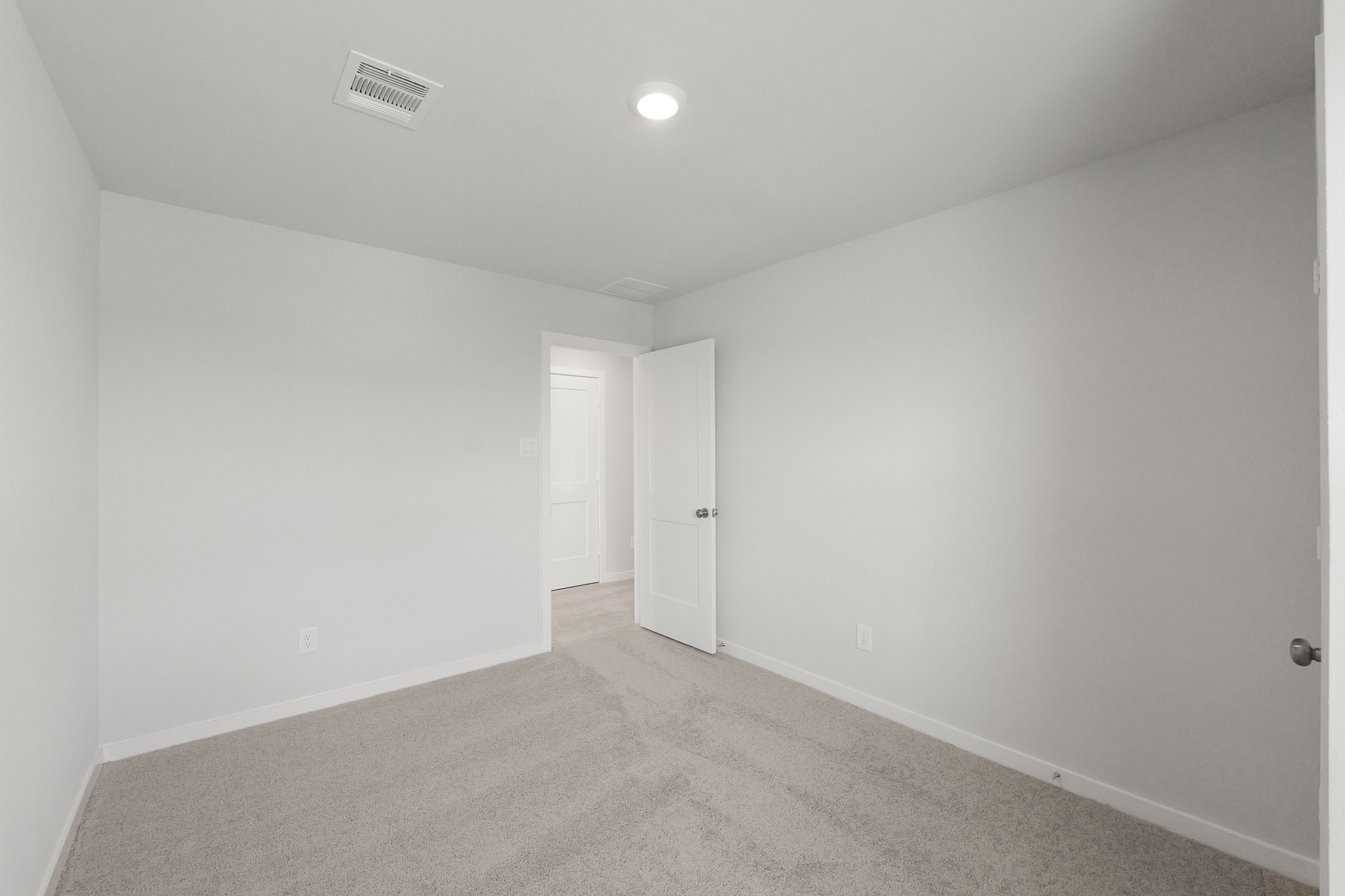 A hallway with white doors.