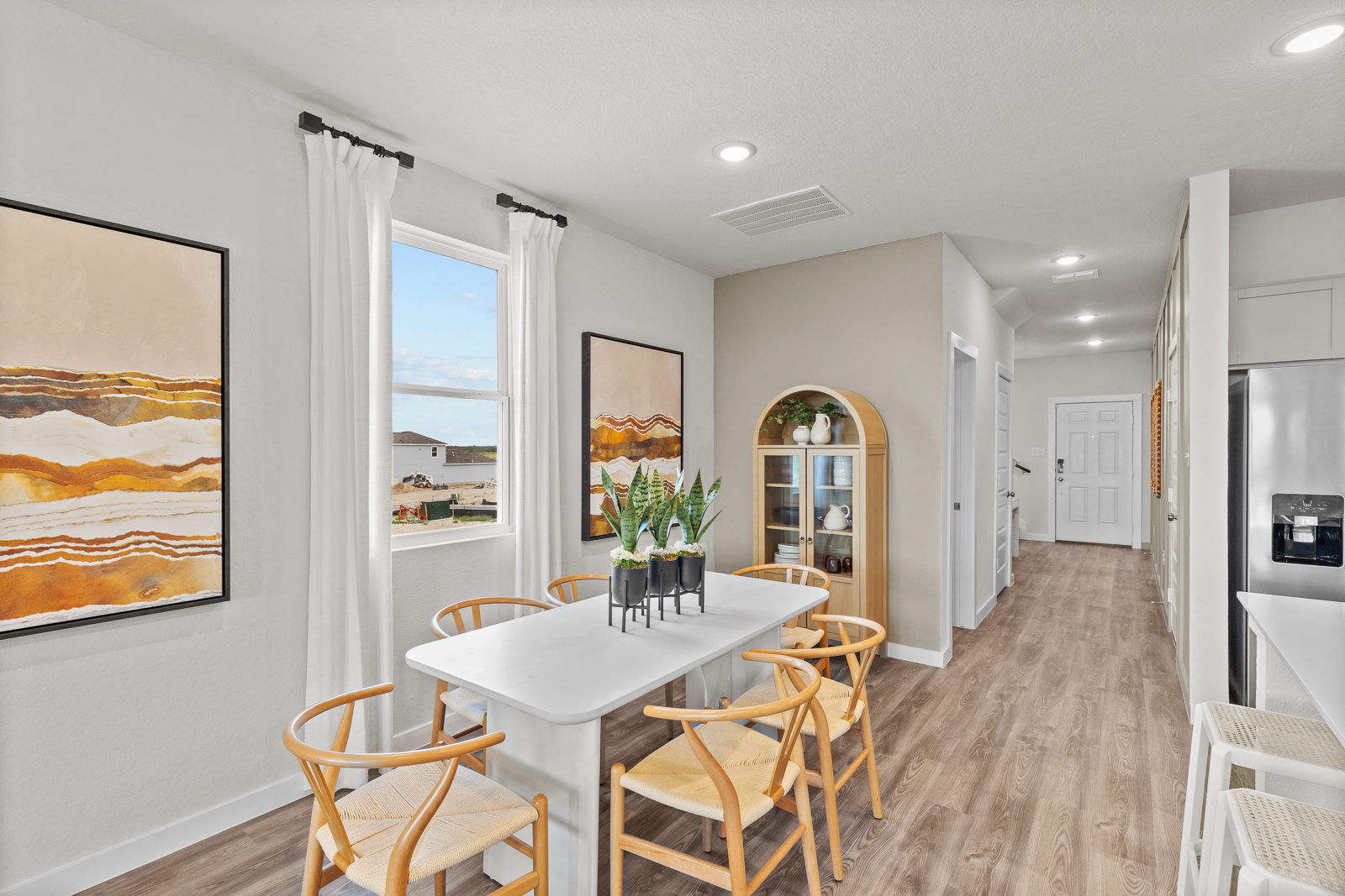 A dining room with a table and chairs.
