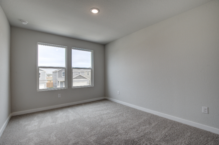 A room with a window and carpet.