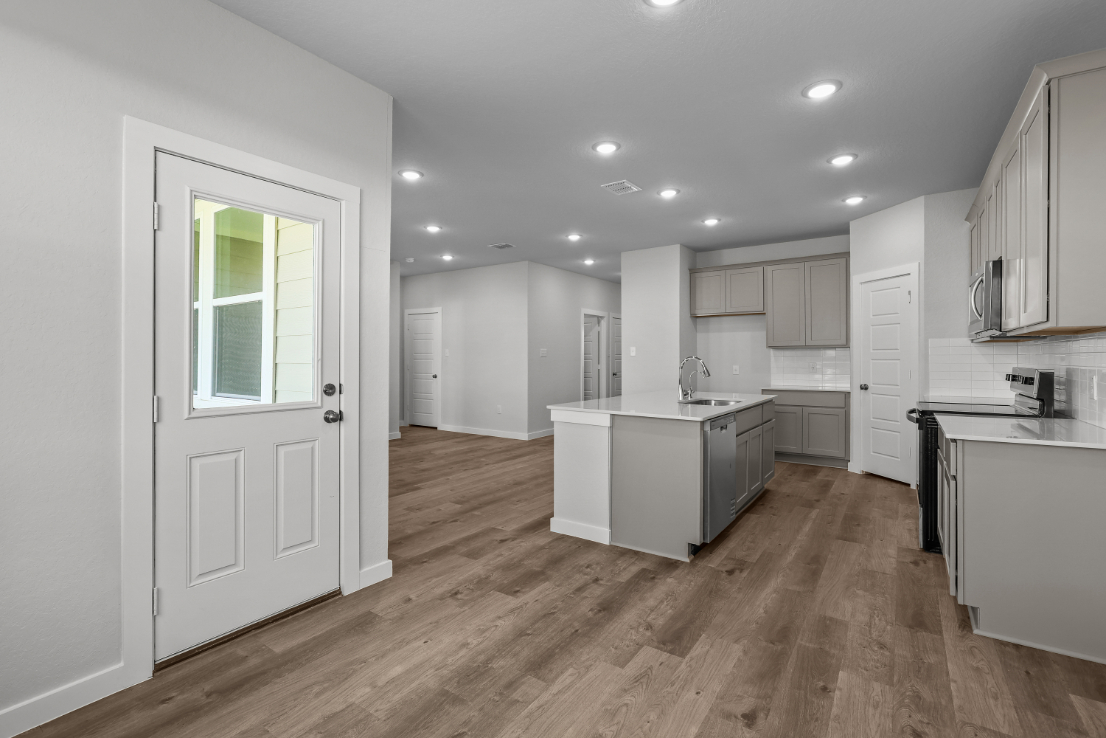 A kitchen with white cabinets.