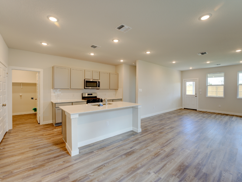 A large kitchen with white cabinets.