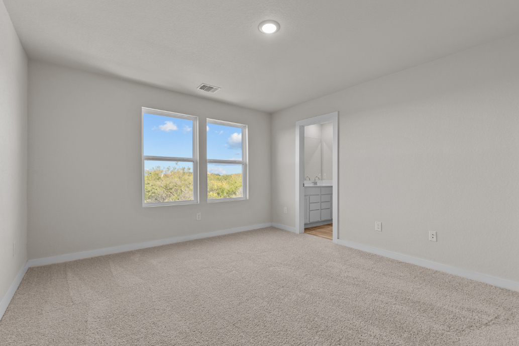 A room with a window and a mirror.