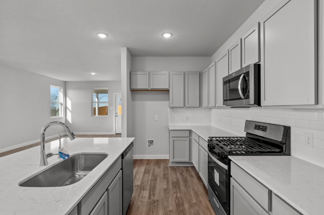 A kitchen with white cabinets.