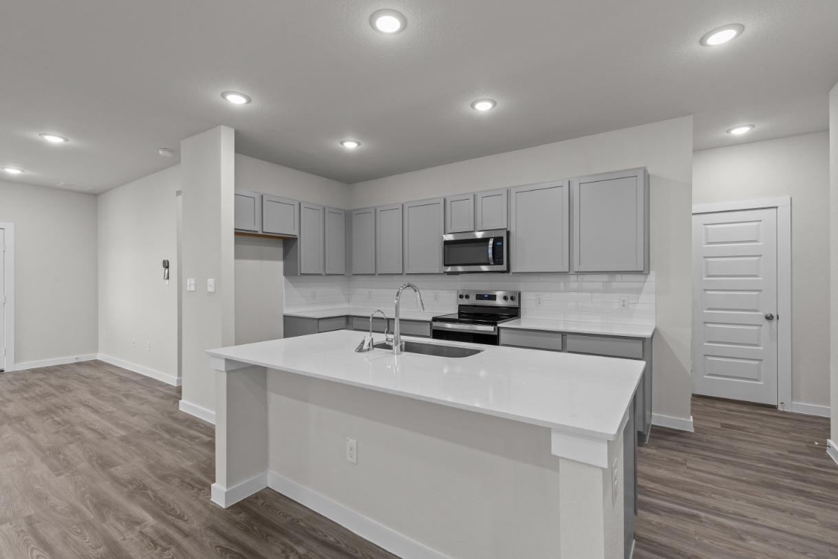 A kitchen with white cabinets.