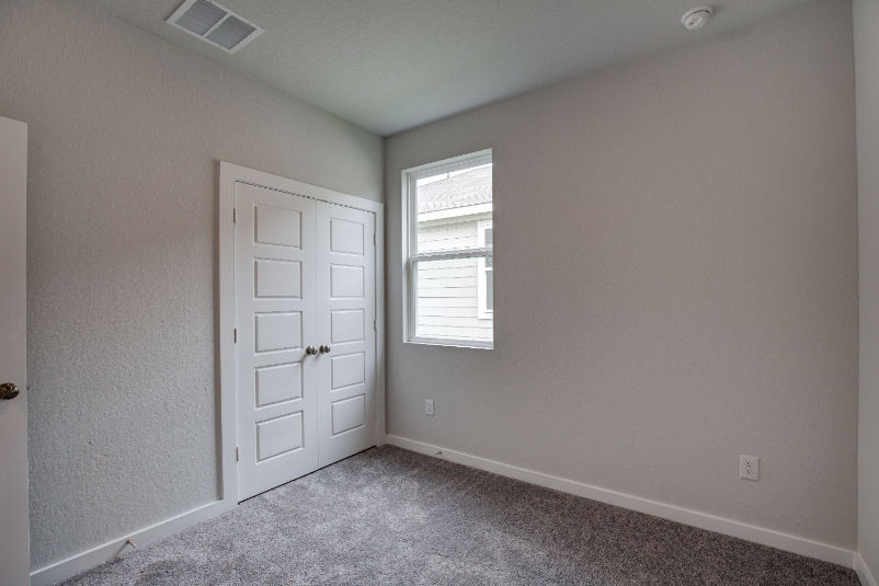 A room with a door and a window.