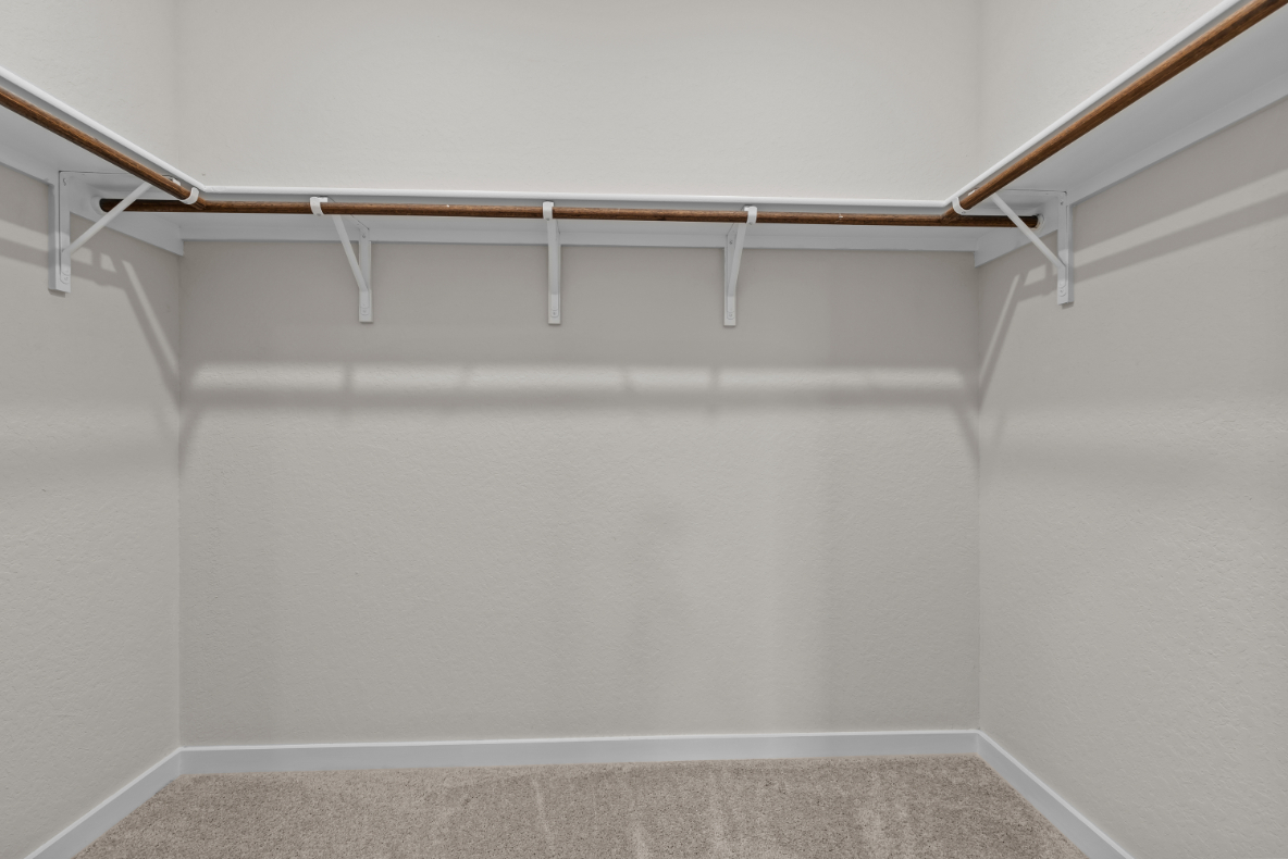 A white wall with a metal railing.