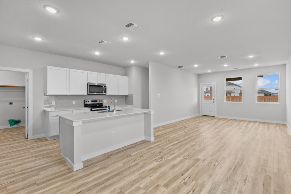 A kitchen with white cabinets.
