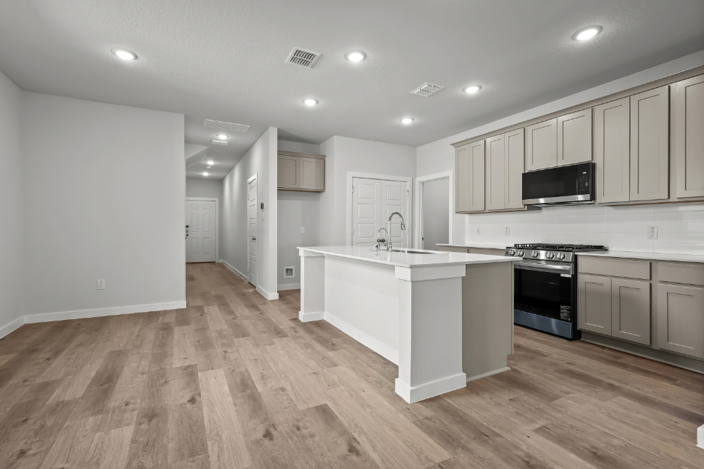A kitchen with white cabinets.