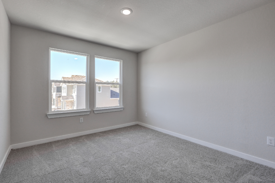 A room with a window and a carpet.