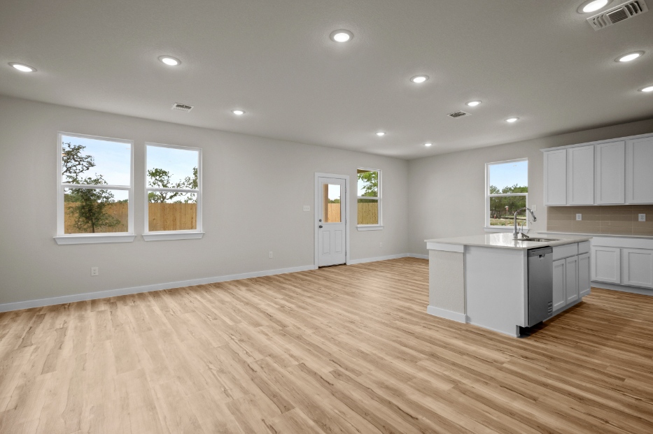 A kitchen with white cabinets.