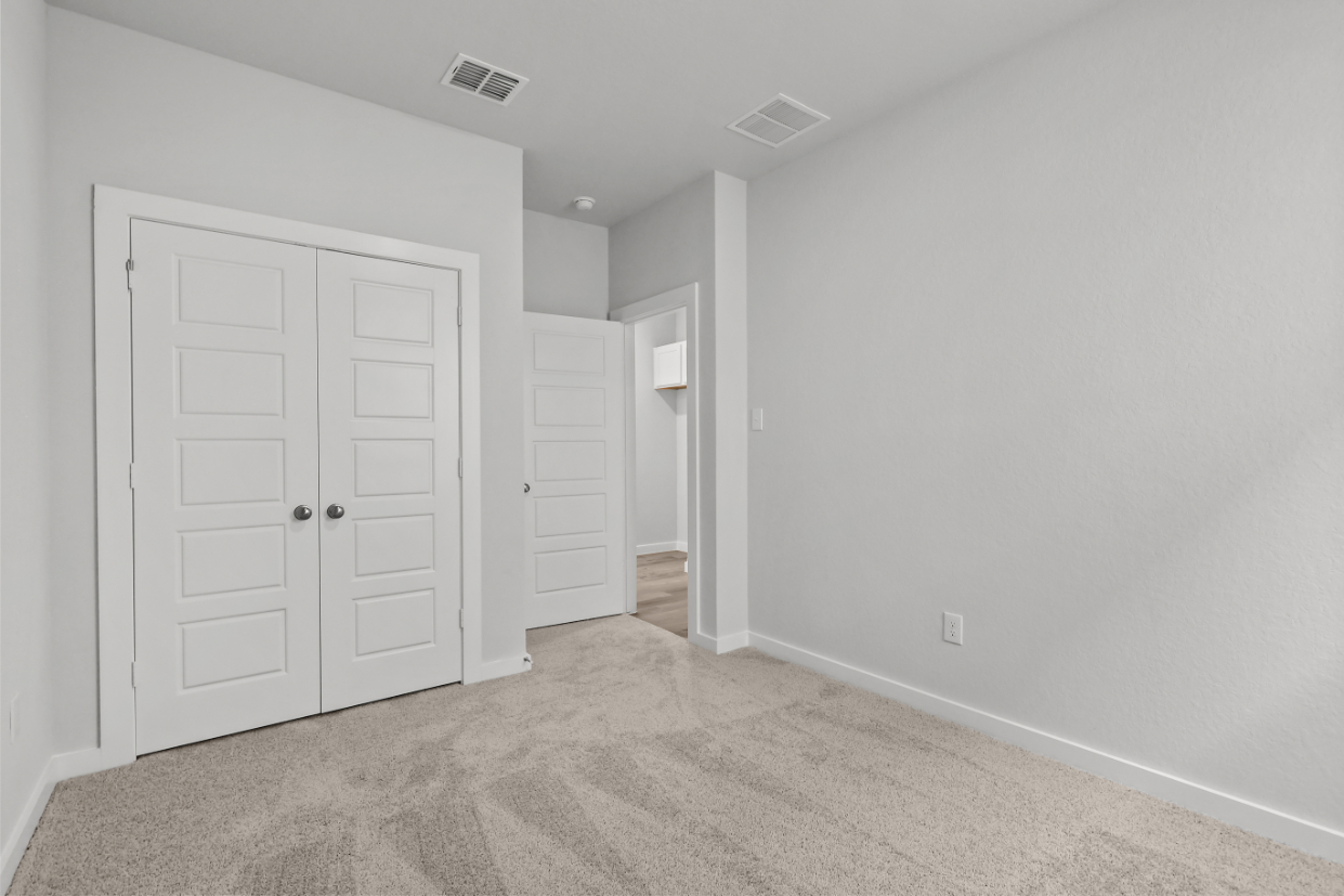 A hallway with white doors.